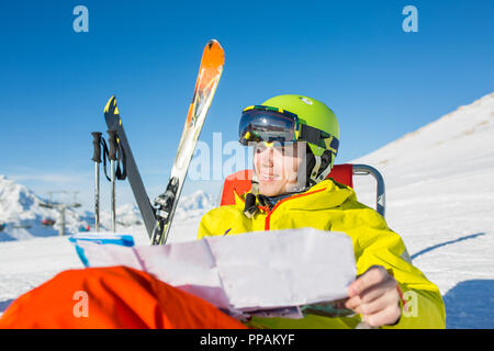 Photo of sporty man in helmet sitting at chair Stock Photo