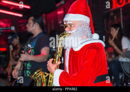 Father Christmas in band, Walking Street, Pattaya, Chonburi, Thailand Stock Photo