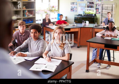 Male High School Tutor Teaching Students In Biology Class Stock Photo