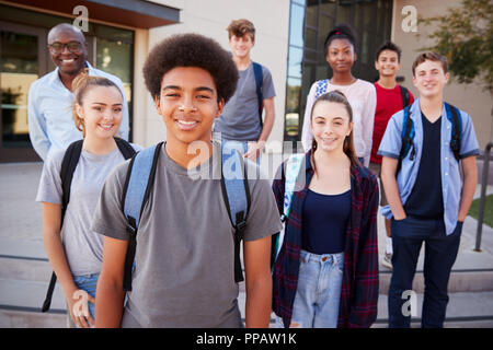 Portrait Of High School Students With Teacher Outside College Buildings Stock Photo