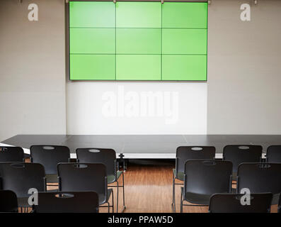 Empty Conference With Green Screen And Chairs Laid Out For Presentation Stock Photo