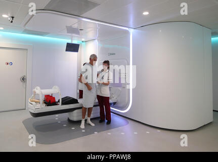 Embargoed to 1700 Monday September 24 Radiographer Gillian Smith helps patient Barry Dolling, aged 65, from Selsdon, Surrey, after treatment using a Magnetic Resonance Linear Accelerator (MR Linac) machine, at the Royal Marsden Hospital in Sutton Surrey. Dolling was diagnosed with prostate cancer in April 2018, and became the first patient in the UK to receive a pioneering new form of radiotherapy. Stock Photo