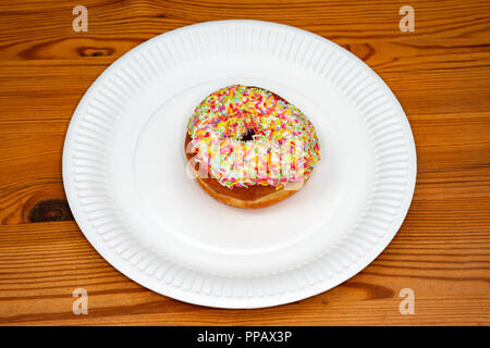 Ring doughnut with rainbow sprinkles Stock Photo