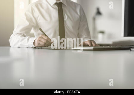 Graphic designer or photographer using a tablet and stylus pen to do photo editing or postproduction. Stock Photo