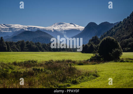 Landscape of the Pumalin National Park in the chilean Patagonia with the Michinmahiuda volcano in the background Stock Photo