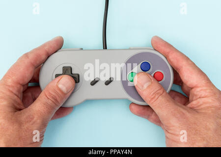 Man playing retro video games with controller Stock Photo