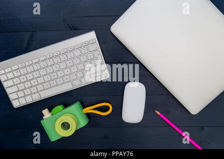 Camera laptop computer keyboard mouse on office desk Stock Photo