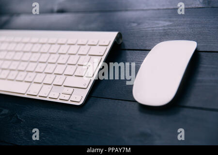 Computer keyboard and white mouse on wood office desk Stock Photo