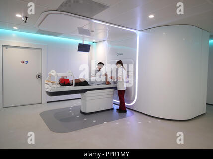 Radiographers Trina Herbert (left), and Gillian Smith help patient Barry Dolling, aged 65, from Selsdon, Surrey, after treatment using a Magnetic Resonance Linear Accelerator (MR Linac) machine, at the Royal Marsden Hospital in Sutton Surrey. Dolling was diagnosed with prostate cancer in April 2018, and became the first patient in the UK to receive a pioneering new form of radiotherapy. Stock Photo