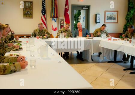 Gen. Curtis M. Scaparrotti, Commander, U.S. European Command and NATO Supreme Allied Commander, Europe, (second from left, table head) takes a break for lunch at the Courage Inn Dinning Facility August 13, 2018 on Joint Base Lewis-McChord. Scaparrotti, a former I Corps commander, spoke as the guest speaker at I Corps Semi-Annual Commander’s Conference Stock Photo