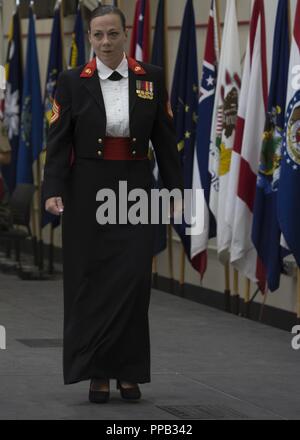 A U.S. Marine with Marine Aircraft Group 39, 3rd Marine Aircraft Wing, dons  the evening dress uniform at the women Marines' 100th year anniversary  during a uniform pageant at Marine Corps Air