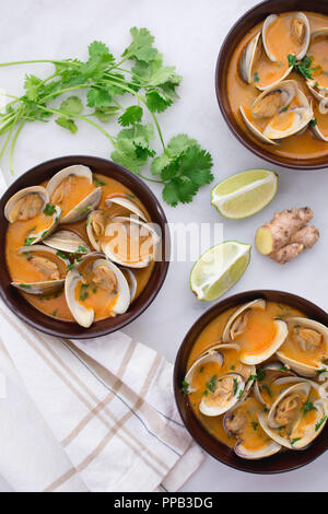 Red Curry, Coconut, and Ginger Infused Steamed Clams Stock Photo
