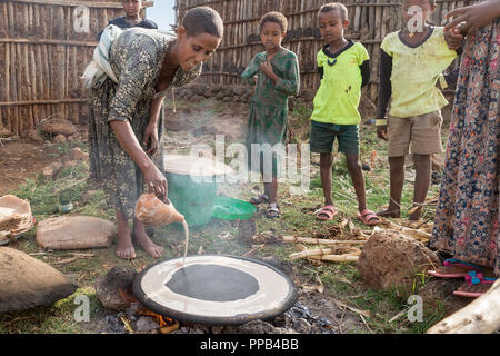 Tigray woman preparing Injera, made from Teff flour & staple to diet, , local villlage to Bahir Dar, Ethiopia, Stock Photo