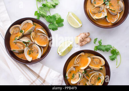 Red Curry, Coconut, and Ginger Infused Steamed Clams Stock Photo