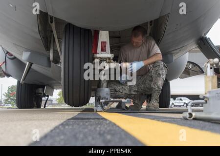 Tech Sgt. Patrick Malter, a crew chief assigned to the 179th Airlift Wing Maintenance Group, changes the front tire on the C-130H Hercules, 'Spirit of Mansfield', on the flight line at the 179th Airlift Wing, Mansfield, Ohio. Airmen from the 179th Airlift Wing perform daily maintenance and run tests on the aircraft to ensure mission readiness at all times. Stock Photo