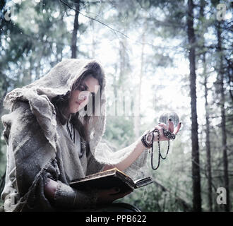 Fairy magician. A sorcerer with a glass sphere, a magical spell  Stock Photo