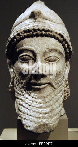 Cyprus. Limestone male head wearing a helmet with a bird. Archaic Period. Last quarter of the 6th century B.C.  It comes from Golgoi (Cyprus). Metropolitan Museum of Art. New York. United States. Stock Photo