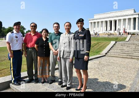 On the steps of the Lincoln Memorial, US Army's 1st Medical Recruiting Battalion welcomed its newest doctor into the fold. Shuyan Huang M.D. of Manassas, VA has officially joined the US Army Medical Corps as of Wednesday, August 15, in Washington, DC. (Pictured from left to right: her recruiter Staff Sgt Stephen Minogue, parents Jinhui Huang, Clarksburg, MD and Jianhui Zhu, MD, PhD of  Clarksburg, MD, husband Yuriy Huang of Manassas, VA, Shuyan Huang, and 1MRB XO Maj Lauren Hamlin. Stock Photo