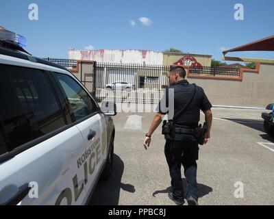 Patrol Officer Michael Pernell of the Robstown Police Department and conducts a post patrol vehicle inspection on August 17, 2018, at Robstown, Texas. Pernell is also a US Army Reserve Human Resources Officer with the 211th Regional Support Group (RSG) based out of Corpus Christi, Texas. Citizen-soldiers like 1st Lt. Pernell have a wide variety of skill sets which ensure America’s Army Reserve units are trained to deploy bringing capable, combat-ready, and lethal firepower in support of the Army and our joint partners anywhere in the world. Stock Photo