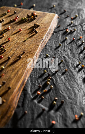 Colour pepper on wooden desk and black table background Stock Photo