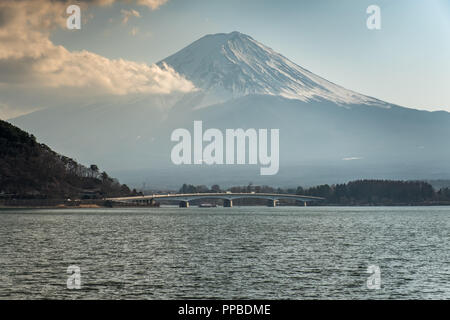 KAWAGUCHI, SAITAMA, JAPAN - 20 FEB 2018: Mount Fuji, lake Kawaguchi-ko and bridge at daytime Stock Photo