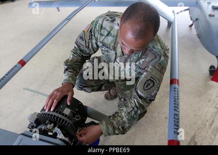 Sgt. Booker, a native of Thomasville, Georgia, and assigned to the Unmanned Aircraft Systems platoon, D Company, 6th Brigade Engineer Battalion,, 4th Infantry Brigade Combat Team (Airborne), 25th Infantry Division, U.S. Army Alaska, conducts maintenance on an RQ-7 shadow Aug. 22 at Joint Base Elmendorf-Richardson, Alaska. Stock Photo