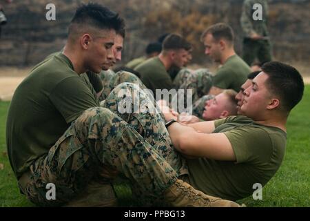 U.S. Marine Corps Cpl. David Avila left assists Pfc. Alec