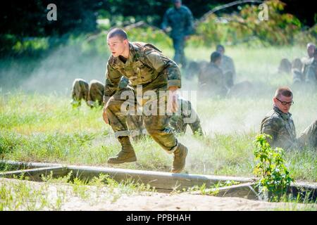 FORT BENNING, Ga (Aug. 31, 2018) – Trainees from Delta Company, 2nd Battalion, 19th Infantry Regiment, train on the Sand Hill Obstacle Course at Fort Benning, Georgia, August 28. The battalion is charged with training and transforming civilians into disciplined, adaptive and flexible Infantrymen, ready to accomplish the mission of the Infantry Corps. Stock Photo