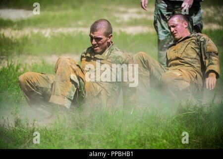 FORT BENNING, Ga (Aug. 31, 2018) – Trainees from Delta Company, 2nd Battalion, 19th Infantry Regiment, train on the Sand Hill Obstacle Course at Fort Benning, Georgia, August 28. The battalion is charged with training and transforming civilians into disciplined, adaptive and flexible Infantrymen, ready to accomplish the mission of the Infantry Corps. Stock Photo