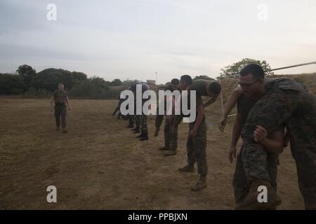 Sri Lanka – U.S. Marines and Sailors with the 13th Marine Expeditionary Unit (MEU) conduct physical training with Sri Lanka Navy Marines while on a regularly scheduled deployment of the Essex Amphibious Ready Group (ARG) and 13th MEU, August 25, 2018. The San Antonio-class amphibious transport dock USS Anchorage (LPD 23) and the embarked Marines of the 13th MEU conducted a theater security cooperation exercise with the Sri Lankan Navy and Navy Marines.  Part of a growing U.S.-Sri Lanka naval partnership, the exercise was also an opportunity for U.S. Seventh Fleet to explore local logistics sup Stock Photo