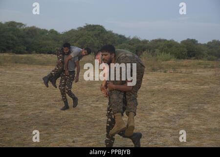 Sri Lanka – U.S. Marines and Sailors with the 13th Marine Expeditionary Unit (MEU) conduct physical training with Sri Lanka Navy Marines while on a regularly scheduled deployment of the Essex Amphibious Ready Group (ARG) and 13th MEU, August 25, 2018. The San Antonio-class amphibious transport dock USS Anchorage (LPD 23) and the embarked Marines of the 13th MEU conducted a theater security cooperation exercise with the Sri Lankan Navy and Navy Marines.  Part of a growing U.S.-Sri Lanka naval partnership, the exercise was also an opportunity for U.S. Seventh Fleet to explore local logistics sup Stock Photo