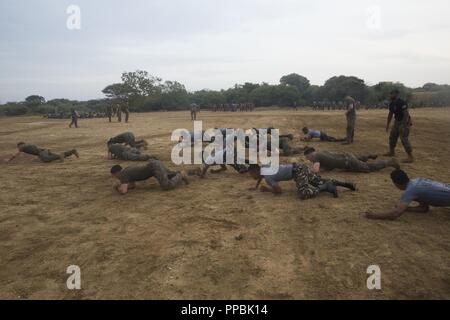 Sri Lanka – U.S. Marines and Sailors with the 13th Marine Expeditionary Unit (MEU) conduct physical training with Sri Lanka Navy Marines while on a regularly scheduled deployment of the Essex Amphibious Ready Group (ARG) and 13th MEU, August 25, 2018. The San Antonio-class amphibious transport dock USS Anchorage (LPD 23) and the embarked Marines of the 13th MEU conducted a theater security cooperation exercise with the Sri Lankan Navy and Navy Marines.  Part of a growing U.S.-Sri Lanka naval partnership, the exercise was also an opportunity for U.S. Seventh Fleet to explore local logistics sup Stock Photo