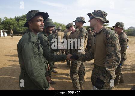 Sri Lanka – Sri Lanka Navy Marines meet and shake hands with U.S. Marines and Sailors assigned to the 13th Marine Expeditionary Unit (MEU) while on a regularly scheduled deployment of the Essex Amphibious Ready Group (ARG) and 13th MEU, August 25, 2018. The San Antonio-class amphibious transport dock USS Anchorage (LPD 23) and the embarked Marines of the 13th MEU conducted a theater security cooperation exercise with the Sri Lankan Navy and Navy Marines.  Part of a growing U.S.-Sri Lanka naval partnership, the exercise was also an opportunity for U.S. Seventh Fleet to explore local logistics s Stock Photo