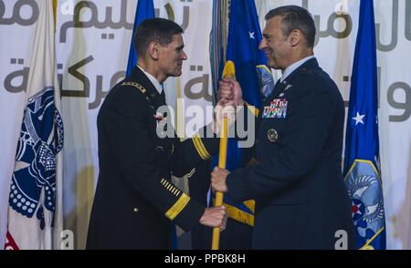 U.S. Army Gen. Joseph L. Votel, Commander of U.S. Central Command (CENTCOM), passes the guidon to U.S. Air Force Lt. Gen. Joseph T. Guastella Jr., Commander of U.S. Air Forces Central Command (AFCENT), during a change of command ceremony at Al Udeid Air Base, Qatar, Aug. 30, 2018. As the Combined Force Air Component Commander for CENTCOM, Guastella is responsible for developing contingency plans and conducting air operations in a 20-nation area of responsibility covering Central and Southwest Asia. AFCENT, in concert with coalition, joint, and interagency partners, delivers decisive air, space Stock Photo