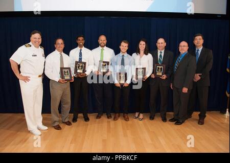 The LHA 6 Total Ship Survivability Trial (TSST) Team receives the Donald F. McCormack Award, which recognizes a small group for collaboration excellence across the Warfare Centers, at the Naval Surface Warfare Center (NSWC), Carderock Division Honor Awards ceremony Aug. 28, 2018, in West Bethesda, Md. From left to right: Commanding Officer Capt. Mark Vandroff; NSWC Carderock’s Laurent Edgell, Jeevan Nalli, Christopher Perich and Michael Persinger; NSWC Philadelphia’s Hannah Demboski and Robert High; Jeff Mercier, head of the Platform Integrity Department; and Dr. Paul Shang, acting technical d Stock Photo