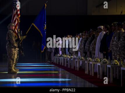 Members of Al Udeid Air Base Honor Guard present the colors during the U.S. Air Forces Central Command (AFCENT) change of command ceremony at Al Udeid Air Base, Qatar, Aug. 30, 2018. Lt. Gen. Joseph T. Guastella Jr. took command of AFCENT from Lt. Gen. Jeffrey L. Harrigian in the first change of command ceremony to be held at AFCENT's forward headquarters in Qatar.  As the new Combined Force Air Component Commander for CENTCOM, Guastella is responsible for developing contingency plans and conducting air operations in a 20-nation area of responsibility covering Central and Southwest Asia. Stock Photo