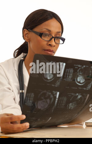 Portrait of female medical doctor reading xrays of patients brain Stock Photo