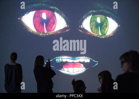 25 September 2018, Berlin: At the opening PK of the exhibition 'The Demon's Brain' by Agnieszka Polska, visitors watch a video installation. With film and animation, the Polish artist presents the fictional story of a rider who delivers documents. Historically based on the Polish salt mine manager Mikolaj Serafin from the 15th century, the installation is supposed to deal with the question of responsibility in today's time. The exhibition at the Hamburger Bahnhof - Museum für Gegenwart begins on 27.09.2018 and ends on 03.03.2019. Photo: Arne Immanuel Bänsch/dpa Stock Photo