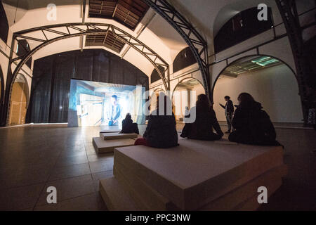 25 September 2018, Berlin: At the opening PK of the exhibition 'The Demon's Brain' by Agnieszka Polska, visitors watch a video installation. With film and animation, the Polish artist presents the fictional story of a rider who delivers documents. Historically based on the Polish salt mine manager Mikolaj Serafin from the 15th century, the installation is supposed to deal with the question of responsibility in today's time. The exhibition at the Hamburger Bahnhof - Museum für Gegenwart begins on 27.09.2018 and ends on 03.03.2019. Photo: Arne Immanuel Bänsch/dpa Stock Photo