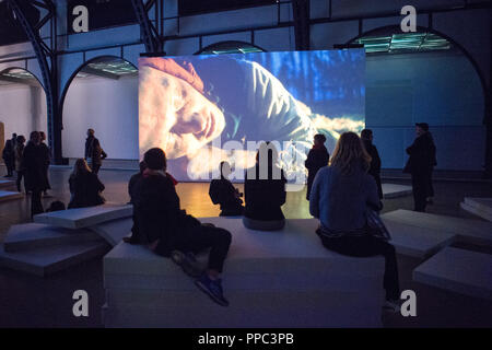 25 September 2018, Berlin: At the opening PK of the exhibition 'The Demon's Brain' by Agnieszka Polska, visitors watch a video installation. With film and animation, the Polish artist presents the fictional story of a rider who delivers documents. Historically based on the Polish salt mine manager Mikolaj Serafin from the 15th century, the installation is supposed to deal with the question of responsibility in today's time. The exhibition at the Hamburger Bahnhof - Museum für Gegenwart begins on 27.09.2018 and ends on 03.03.2019. Photo: Arne Immanuel Bänsch/dpa Stock Photo