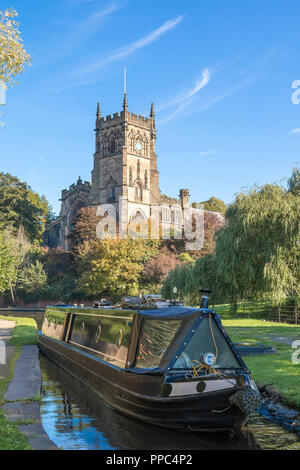 Kidderminster, UK. 25th September, 2018. UK weather: after an unseasonably cold evening and chilly start, the folk of Kidderminster welcome this morning's glorious autumn sunshine which is set to last for the remainder of the day. A British couple are here enjoying their UK staycation, on a boating holiday navigating a canal narrow boat through the Kidderminster lock by St. Mary's Church. Credit: Lee Hudson/Alamy Live News Stock Photo