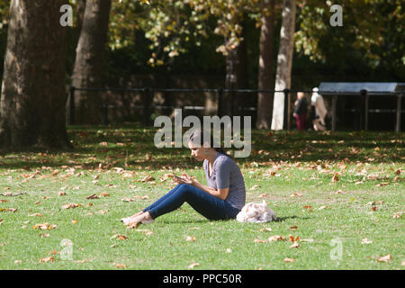 London UK. 25th September 2018. People enjoy the warm afternoon autumn sunshine in Saint James's Park London as an Indian Summer with warm weather  and unusually high temperatures is forecast for the month of October in London Credit: amer ghazzal/Alamy Live News Stock Photo