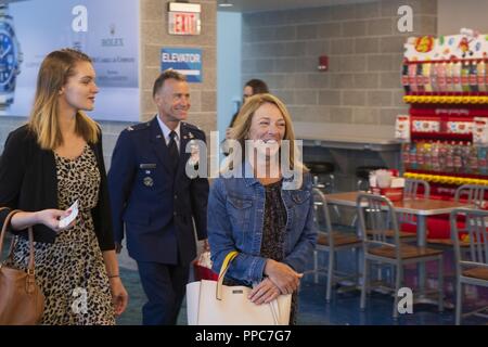 Valerie Nessel, right, the widow of U.S. Air Force Tech. Sgt. John Chapman, walks alongside her daughter Brianna, left, to her airline gate at Destin-Fort Walton Beach Airport, Florida, Aug. 20, 2018. President Donald Trump will posthumously award the Medal of Honor to Chapman's family at a ceremony on August 22 for his extraordinary heroism in March 2002 while deployed to Afghanistan. Stock Photo