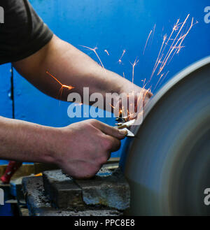 knife sharpening machine and master. Grinding machine. grinding knife using  abrasive stone Stock Photo - Alamy