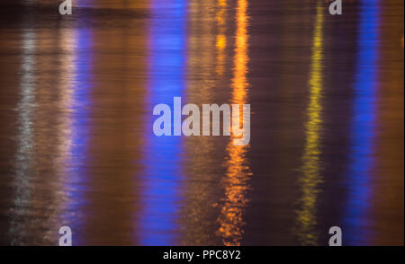 Lights reflecting in rippled sea water surface Stock Photo