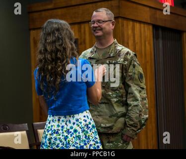 Debra Foster pins the rank of Colonel on her husband Chaplain Steve Foster during Foster’s promotion ceremony at Camp Lincoln, Springfield, Illinois, on Aug. 21. Foster is the Senior Army Chaplain for the Illinois National Guard. Stock Photo