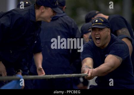 Members of the Coast Guard Cutter Sycamore fight passed the point of exhaustion during the tug-o-war competition as part of the Buoy Tender Olympics at Coast Guard Station Juneau, Alaska, Aug. 22, 2018. The Olympics is a competition that not only builds morale amongst cutter members but also provides a fun alternative to every day training in events such as the chain pull, survival swim and the heat-and-beat. Stock Photo