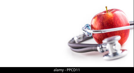 Close-up stethoscope and red apple  on white background. Stock Photo
