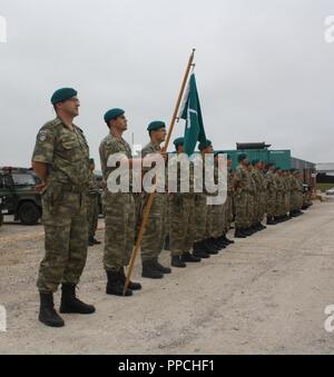 KFOR Multi-National Battle Group - East Turkish Infantry Company Commander Capt. Mehmet Onat, left, stands with his troops at Camp Bondsteel, Kosovo, Aug. 28. Stock Photo