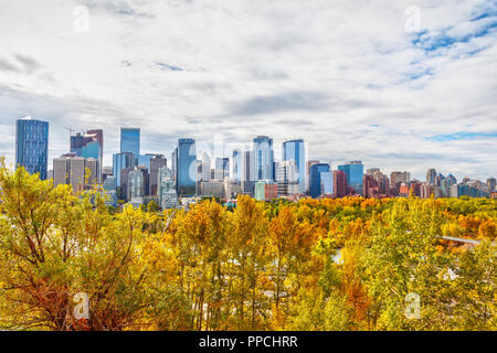 Calgary downtown skyline during Fall or Autumn with colorful trees surrounding the financial district and its skyscrapers. As viewed from Sunnyside Ba Stock Photo